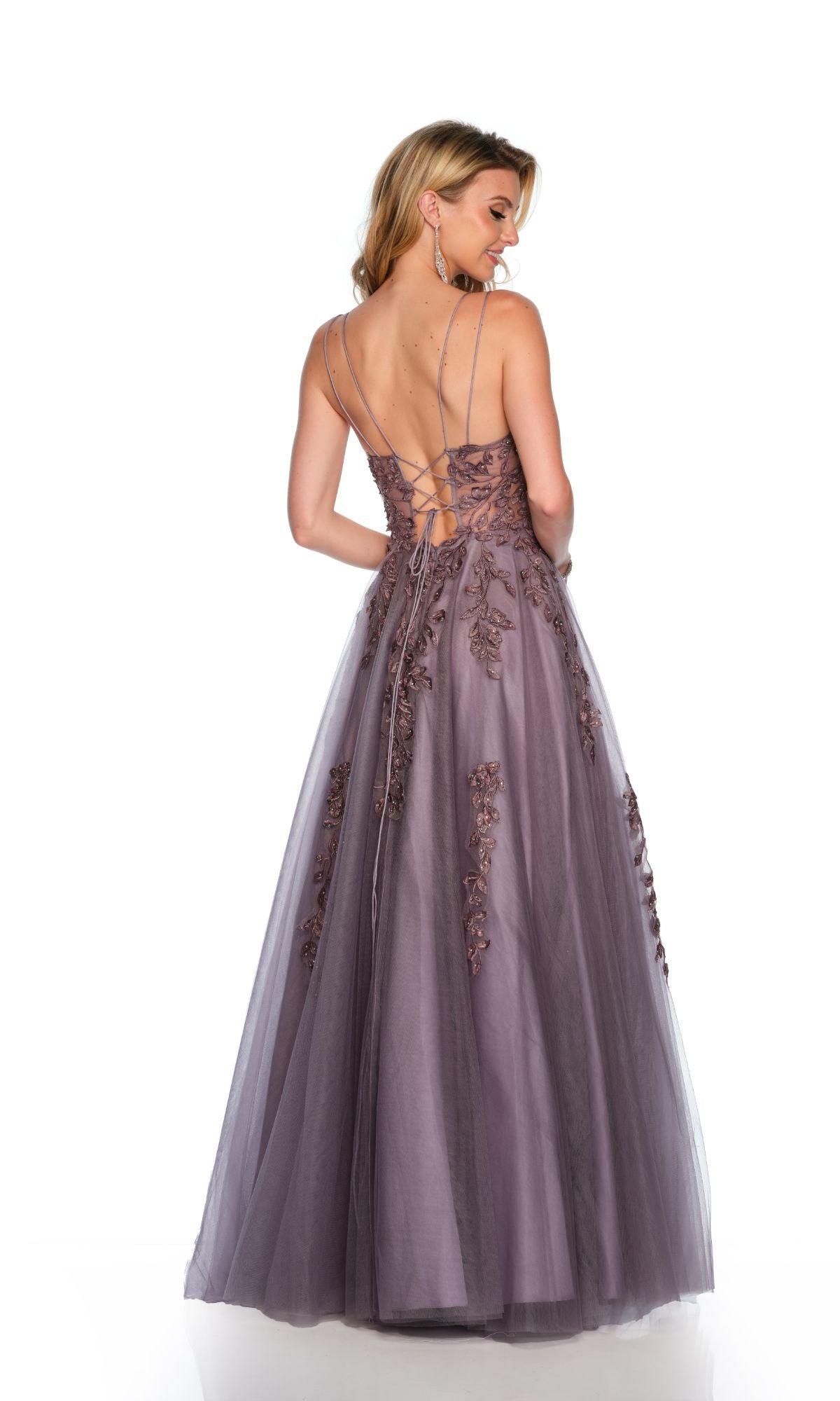 A woman poses gracefully with her back to the camera, wearing the Long Formal Dress 11653 by Dave and Johnny—an A-line tulle ball gown featuring floral lace embroidery and a dramatic open back.
